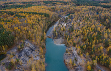 Aerial view of small lakes surrounded by autumn forest.