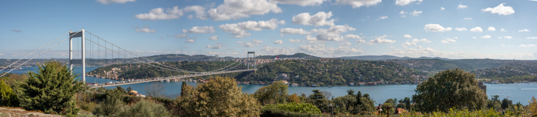 Fototapeta na wymiar ISTANBUL, TURKEY - OCTOBER 12 ,2021: Panoramic view of Istanbul Bosphorus. Istanbul Fatih Sultan Mehmet Bridge. cloudy blue sky. panorama