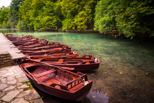 Boats parking at pier with crystal clear lake landscape of Plitvice Lakes National Park, UNESCO heritage. Plitvice Lakes are famous travel destination of Croatia.