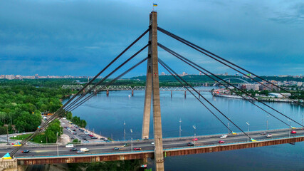 Beautiful aerial drone view of the North bridge in Kiev (Ukraine), sunset and cityscape of Kiev.
