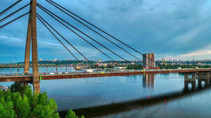 Beautiful aerial drone view of the North bridge in Kiev (Ukraine), sunset and cityscape of Kiev.
