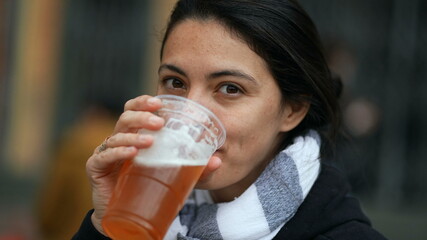 Woman drinking beer pint outside
