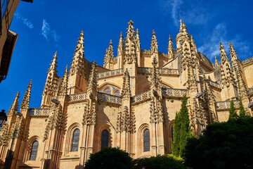 Fototapeta na wymiar Apse topped by pinnacles, of the Segovia Cathedral, a catholic temple devoted to the Assumption of the Virgin Mary and San Frutos. View from Plaza Mayor square. Segovia, Spain.