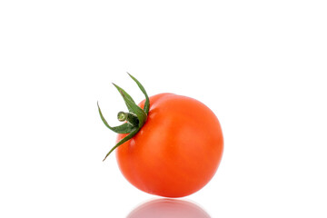 One red organic tomato, close-up, isolated on white.