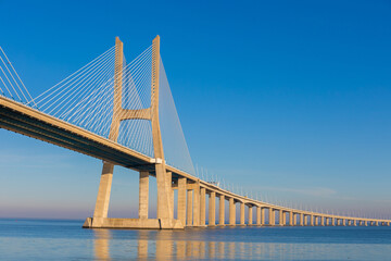 Mesmerizing view of Vasco da Gama Bridge against clear blue sky in Sacavem, Portugal - Powered by Adobe