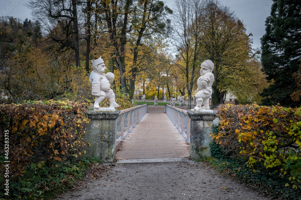 Wall mural Bridge to Dwarf Garden (Zwergerlgarten) with Pallone Player Dwarfs  - 17th century statues - Salzburg, Austria