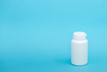 White different medical or cosmetic jars on a blue background as a concept of cosmetology of medecine and treatment