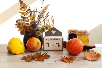 Calendar for November 13 : the name of the month in English, the number 13 , a bouquet of dried...