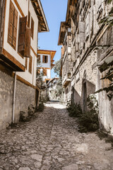 Fototapeta na wymiar Turkey Safranbolu historic street and houses. Stone roads and wooden ottoman mansions. Safranbolu UNESCO World Heritage Site.