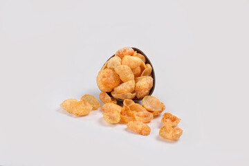 Fried and Spicy Moon Cup, Vatka, Katori, Moon Chips, Snacks or Fryums (Snacks Pellets) served in a bowl or White background. selective focus - Image