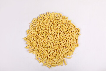 Gathiya Indian Namkeen Bhavnagari Gathiya or Ganthiya. Besan Gathiya Popular Gujarati snack made from gram flour (chickpea flour), isolated served in Yellow bowl on white background. Deep fried snacks