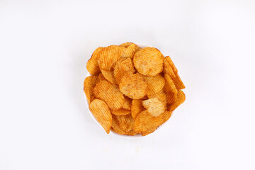 Bowl of tasty ridged potato chips on white background | top angle beautiful focused