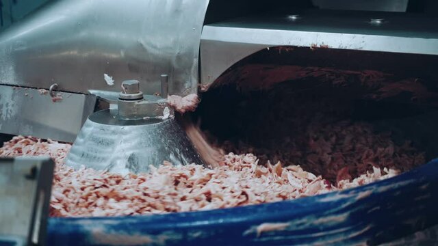 The working process of a meat grinder at a meat processing plant