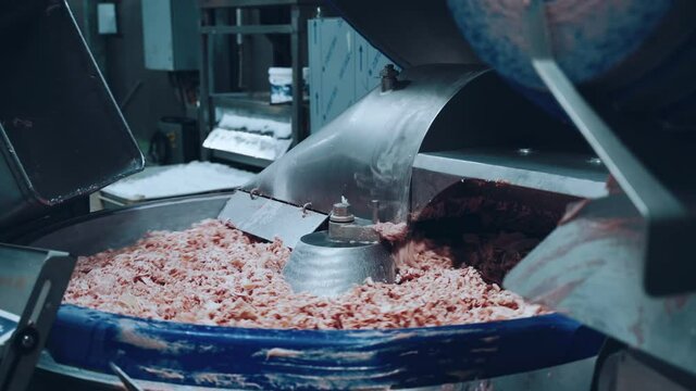 The working process of a meat grinder at a meat processing plant