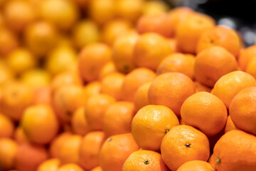 texture of yellow tangerines or mandarins, natural background, selective focus, side view