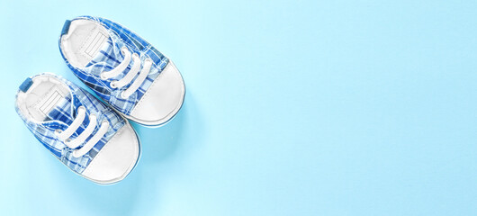 Top view of baby blue shoes on a blue banner background with free text space