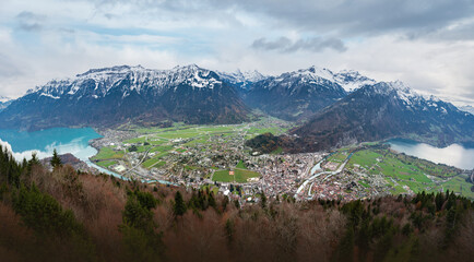 Fototapeta na wymiar Panoramic aerial view of Interlaken and Unterseen between Lakes Thun and Brienz with Bernese Alps Mountains on background - Interlaken, Switzerland