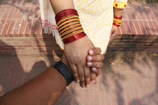 Point-of-view (POV) of a man holding a woman's hand