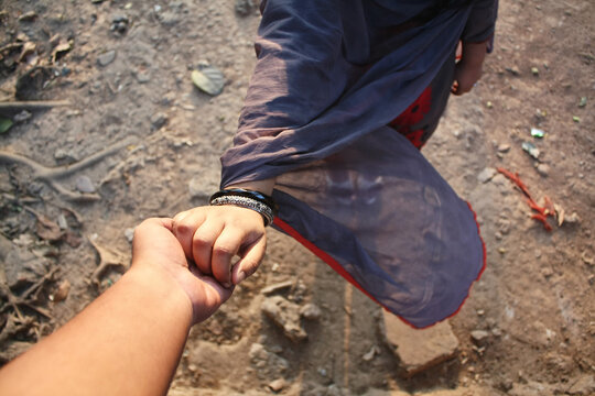 Point-of-view (POV) of a man holding a woman's hand