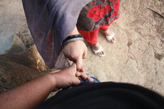 Point-of-view (POV) of a man holding a woman's hand