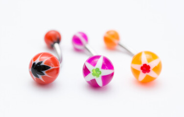 A set of jewelry for piercing on a white background. A set of earrings for the body, nose, navel, tongue, nipples, ears, various beauty jewelry, a set of cosmetological jewelry for piercing.