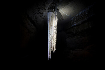 illuminated large stalactite in doolin cave in ireland