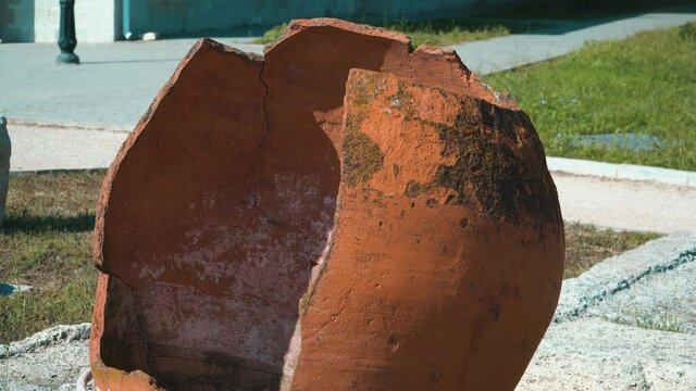 Broken ancient orange amphora without a piece