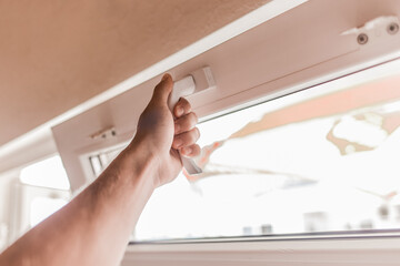 The guy's hand opens a plastic double window for the handle pvc double glazing