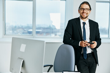 man in a suit near the desktop office computer Lifestyle