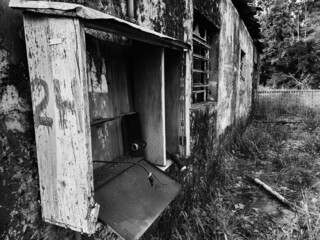 Wooden electricity meter box of old abandoned house