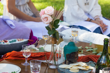 boho style picnic in park babyshower with wine and lantern