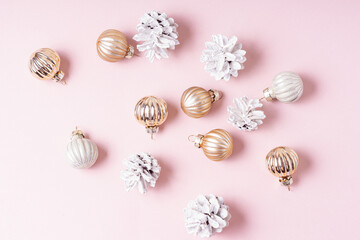 White cones and small Christmas balls on pink background. Happy New Year and Christmas celebration