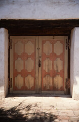 old wooden door in a wall of mission