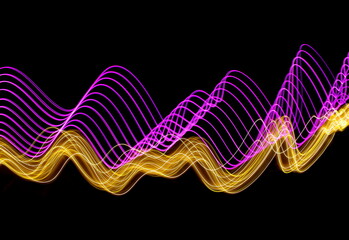 Long exposure photograph of neon pink and gold colour in an abstract swirl, parallel lines pattern against a black background. Light painting photography.