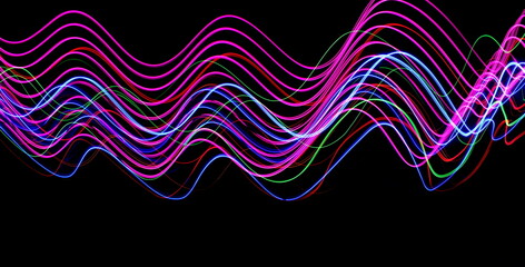 Long exposure photograph of neon colour in an abstract swirl, parallel lines pattern against a...
