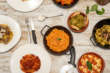 set of typical Italian dishes of pasta with tomato, gnocchi, pasta with truffle, wheat flour and basil