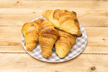 shredded plate filled with butter croissants for a delicious breakfast