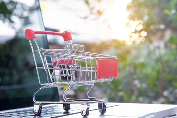 Shopping online - shopping cart or trolley on a laptop keyboard. Shopping service on The online web.