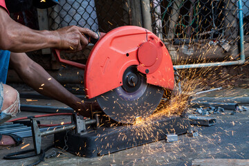 Worker cut steel with cut off wheel saw, cutting wheels.