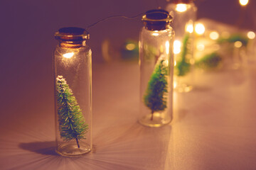 Merry Christmas and happy new year concept, Light bulb and small Christmas tree in glass jar