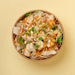 Rice Noodle Bowl with chicken, broccoli, beansprout, carrot, and peanut sauce 