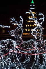 Lighting decoration deers with christmas tree on the background in the city of Gomel during New...