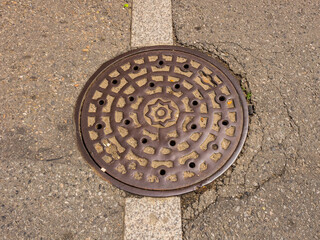 Round sewer hatch on the street in Seoul downtown, South Korea
