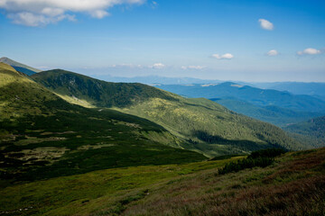 Fototapeta premium Incredibly beautiful panoramic views of the Carpathian Mountains. Peaks in the Carpathians on a background of blue sky
