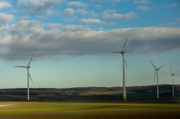Wind turbines farm in green field