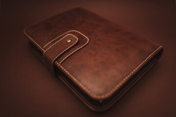 Leather book (notebook) on brown background