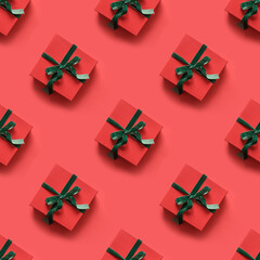 Seamless pattern of Christmas red gifts with green ribbon on red background. Xmas.