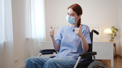 A young disabled woman is putting on a mask on her face