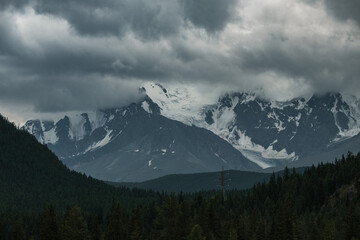 Fototapeta na wymiar View beyond the snow-capped peaks of the mountains near Aktash in the Altai Republic