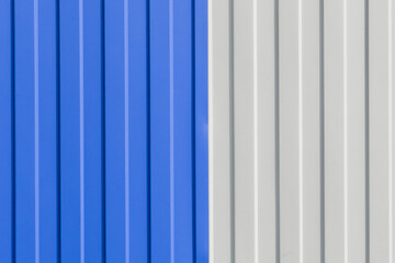 Obraz premium Blue and White Painted Sheet Metal Plates Iron Fence Texture Background